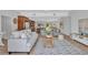Open-concept living room featuring stylish decor and comfortable seating, flowing into the dining and kitchen areas at 4099 Pompano Se Dr, St Petersburg, FL 33705