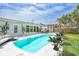 Backyard featuring a pool, patio, pergola, and lush landscaping at 4099 Pompano Se Dr, St Petersburg, FL 33705