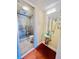 Bathroom with a glass bowl sink, a sleek vanity, and a glass-enclosed tiled shower at 4117 Muriel Pl, Tampa, FL 33614