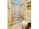 Updated bathroom with a glass shower enclosure, toilet, and tile flooring for a modern touch at 4117 Muriel Pl, Tampa, FL 33614