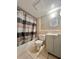 Cozy bathroom featuring a shower-tub combo, modern vanity, toilet and tiled floor at 4117 Muriel Pl, Tampa, FL 33614