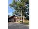 Two-story home with modern architecture, mature trees, a well-manicured lawn, and a paved driveway at 4117 Muriel Pl, Tampa, FL 33614