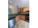 Kitchen featuring stainless steel appliances, stone countertops and wooden cabinets at 4117 Muriel Pl, Tampa, FL 33614