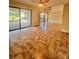 Open living room space featuring tile floors, a spiral staircase, and sliding door access to a patio at 4117 Muriel Pl, Tampa, FL 33614