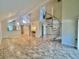 Spacious living room with high ceilings, tile floors, and a modern spiral staircase at 4117 Muriel Pl, Tampa, FL 33614