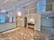 Bright living room with modern lighting, sleek wet bar, and open access to kitchen at 4117 Muriel Pl, Tampa, FL 33614