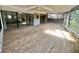 Large screened patio with wood flooring and stone accents, perfect for outdoor relaxation at 4117 Muriel Pl, Tampa, FL 33614
