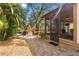 Charming brick patio with outdoor seating and lush landscaping creates a serene backyard retreat at 419 W Osborne Ave, Tampa, FL 33603