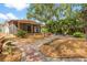 Expansive backyard features a screened porch, brick patio, and lush landscaping, creating an ideal outdoor space at 419 W Osborne Ave, Tampa, FL 33603