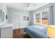Bedroom with hardwood floors, ceiling fan, and bright windows with curtains at 419 W Osborne Ave, Tampa, FL 33603