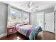 Bedroom with hardwood floors, large windows, ceiling fan, and access to ensuite bathroom at 419 W Osborne Ave, Tampa, FL 33603