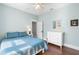 Cozy bedroom featuring wood floors, a white dresser, and a comfortable queen-sized bed at 419 W Osborne Ave, Tampa, FL 33603