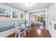 Dining nook with a glass table, cushioned bench, and view into the living room at 419 W Osborne Ave, Tampa, FL 33603