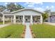 Charming craftsman-style bungalow featuring a covered front porch and well-manicured lawn at 419 W Osborne Ave, Tampa, FL 33603