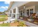 Inviting front porch with seating and decorative planters offers a welcoming entrance to this charming home at 419 W Osborne Ave, Tampa, FL 33603