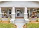 Inviting front porch with brick supports, planters, and a rocking chair, perfect for relaxing at 419 W Osborne Ave, Tampa, FL 33603