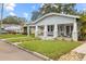 Charming bungalow with a well-manicured lawn and inviting front porch at 419 W Osborne Ave, Tampa, FL 33603