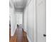 Hallway featuring hardwood floors, neutral paint, and access to various rooms at 419 W Osborne Ave, Tampa, FL 33603