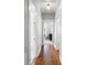 Bright hallway featuring hardwood floors and white doors leading to various rooms at 419 W Osborne Ave, Tampa, FL 33603