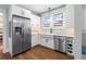 Bright kitchen featuring white cabinets, stainless steel appliances, and a farmhouse sink at 419 W Osborne Ave, Tampa, FL 33603