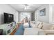 Open-concept living room with light walls, hardwood floors, and a view into the dining area at 419 W Osborne Ave, Tampa, FL 33603