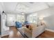 Bright living room featuring hardwood floors, decorative ceiling, and large windows at 419 W Osborne Ave, Tampa, FL 33603