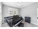 Living room featuring piano, side table, neutral paint, and light-filled windows at 419 W Osborne Ave, Tampa, FL 33603