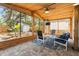 Covered back porch with ample seating and view of the landscaped backyard at 419 W Osborne Ave, Tampa, FL 33603