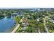 Aerial view of a home on the water featuring lush landscaping and waterfront access at 4321 Sunrise S Dr, St Petersburg, FL 33705