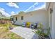 Private backyard featuring a patterned patio, comfortable outdoor seating, and manicured landscaping at 4321 Sunrise S Dr, St Petersburg, FL 33705