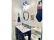 Nautical-themed bathroom with shiplap walls, blue accents, and stylish fixtures at 4321 Sunrise S Dr, St Petersburg, FL 33705
