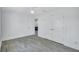 This bedroom has neutral walls, modern floors, and a glimpse into a kitchen area at 4321 Sunrise S Dr, St Petersburg, FL 33705
