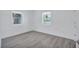 Bright bedroom with wood-look flooring and natural light from two windows at 4321 Sunrise S Dr, St Petersburg, FL 33705