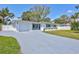 Charming single-story home featuring a driveway, manicured lawn, and well-kept landscaping at 4321 Sunrise S Dr, St Petersburg, FL 33705