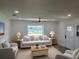 Cozy living room with waterfront views, neutral furniture, and a ceiling fan at 4321 Sunrise S Dr, St Petersburg, FL 33705