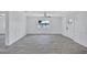 Bright living room with wood-look floors, white walls, and a view of the water at 4321 Sunrise S Dr, St Petersburg, FL 33705
