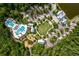 Aerial view showcasing the community pool, playground, and clubhouse nestled in lush greenery at 4345 Cadence Loop, Land O Lakes, FL 34638