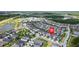 Aerial view of the neighborhood featuring a home marked with a red locator at 4345 Cadence Loop, Land O Lakes, FL 34638