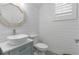 Stylish bathroom features shiplap walls, modern vanity, vessel sink and decorative mirror at 4345 Cadence Loop, Land O Lakes, FL 34638