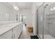Bathroom featuring a double sink vanity, walk-in shower, and access to bedroom at 4345 Cadence Loop, Land O Lakes, FL 34638