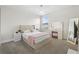 Bright bedroom featuring soft carpet, a well-lit vanity, and a plush bed with matching decor at 4345 Cadence Loop, Land O Lakes, FL 34638