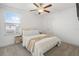 Serene bedroom with soft carpet, neutral decor, a plush bed, and bright natural light from the window at 4345 Cadence Loop, Land O Lakes, FL 34638