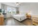 Inviting bedroom with hardwood floors, natural lighting, and a neutral color palette at 4345 Cadence Loop, Land O Lakes, FL 34638