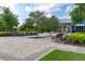 Community clubhouse with ample seating, a well-manicured lawn, and decorative foliage at 4345 Cadence Loop, Land O Lakes, FL 34638