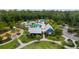 Aerial image of the community pool, club house and playground surrounded by lush landscaping at 4345 Cadence Loop, Land O Lakes, FL 34638