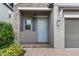 Inviting entryway with stone accents, a light blue door, and a brick pathway leading up to the entrance at 4345 Cadence Loop, Land O Lakes, FL 34638