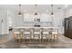 Bright kitchen features a large center island, bar stool seating, pendant lighting and white cabinetry at 4345 Cadence Loop, Land O Lakes, FL 34638