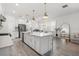 Open kitchen with stainless steel appliances, island with seating, and adjacent dining area at 4345 Cadence Loop, Land O Lakes, FL 34638