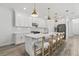 Bright kitchen with white cabinets, subway tile backsplash, and quartz countertops, perfect for cooking and entertaining at 4345 Cadence Loop, Land O Lakes, FL 34638