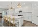 Bright kitchen featuring a white island with seating, stainless appliances, and ample counter space for meal preparation at 4345 Cadence Loop, Land O Lakes, FL 34638
